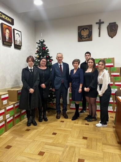 Uroczyste spotkanie senatora Gogacza z nauczycielami i młodzieżą w tle paczki z darami